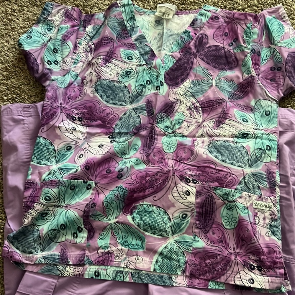 Scrubs for a nurse in top is a med  other top is a large and bottoms are med pet